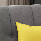 Fauteuil club capitonné en tissu avec passepoil Angelina Mid-Century GDFStudio